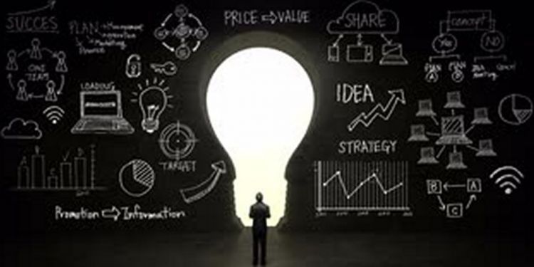 businessman standing in front of black shape of bulb light business plan and various graph in black wall concept nzanncdog S0014 1024x768 min eea2c